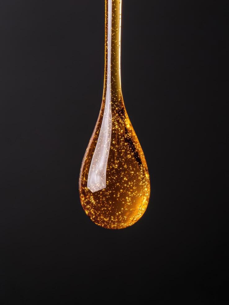 Sparkling golden water droplet photo