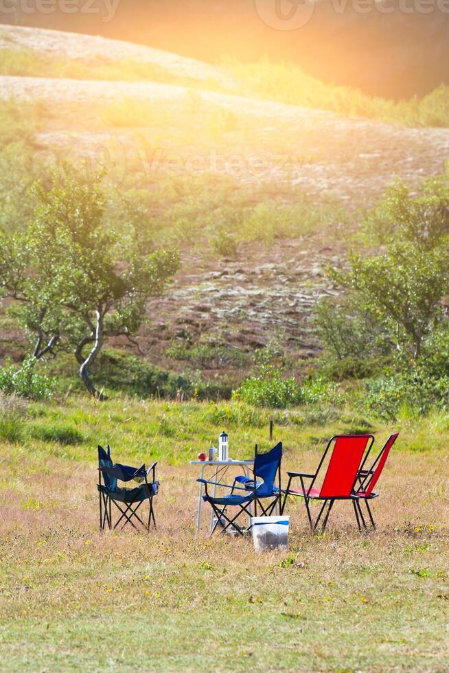 Camping site with camp-chairs and table photo