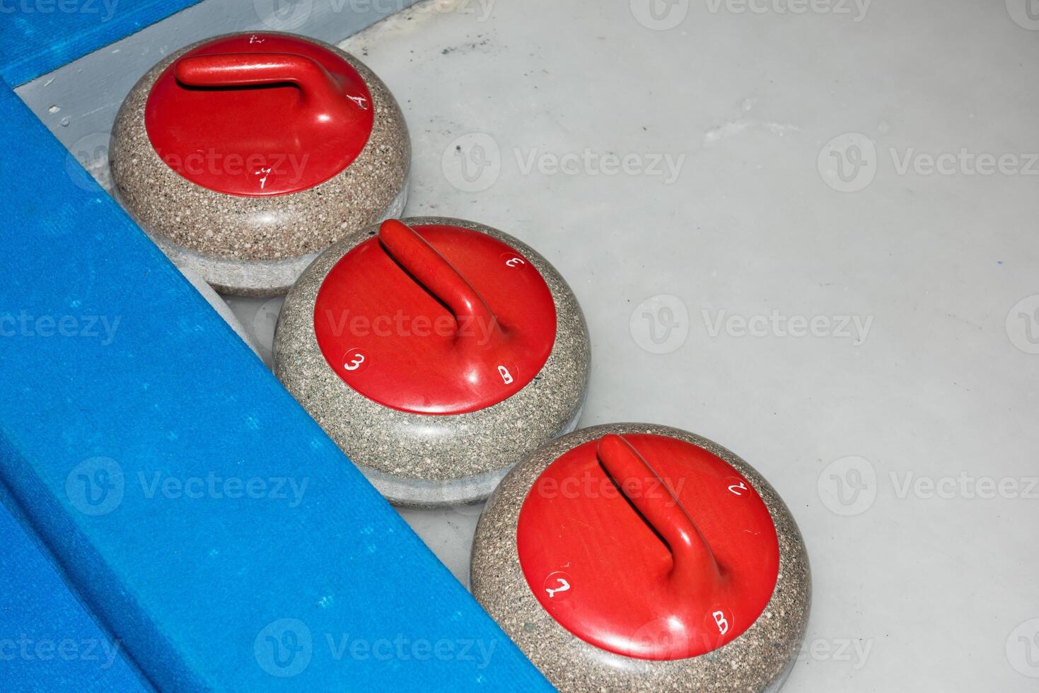 Curling stones on the ice photo