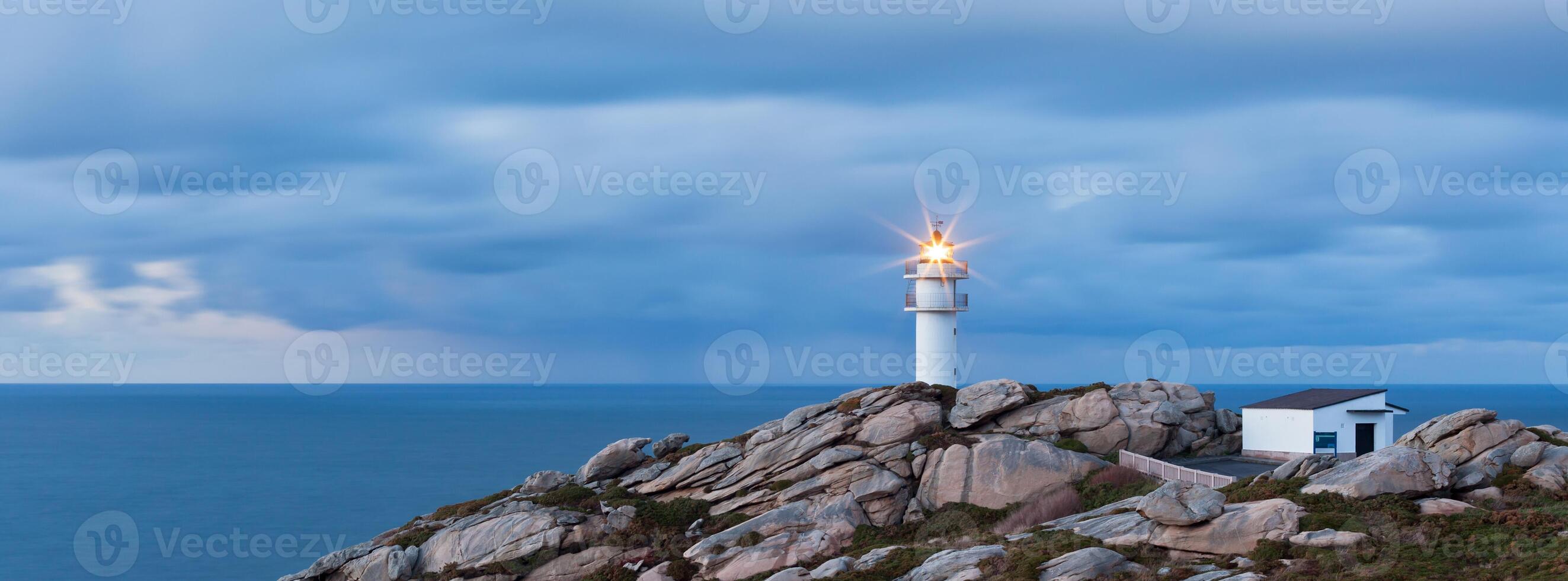 Working Lighthouse at Northern Spain in Bad Weather photo