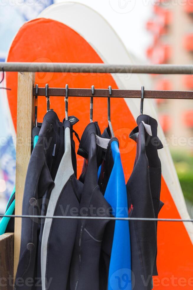 Diving suits and surf boards in a store photo