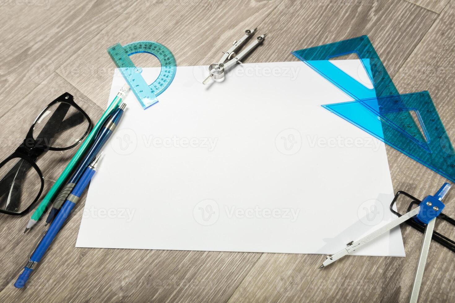 Blank notebook and pencil with glasses on wooden table photo