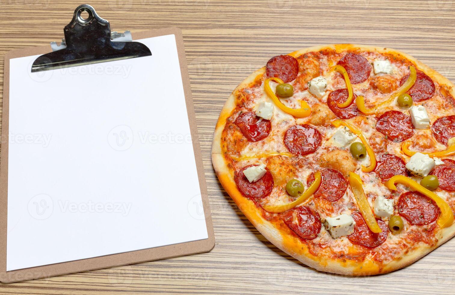 Pizza with blank paper with copy space photo