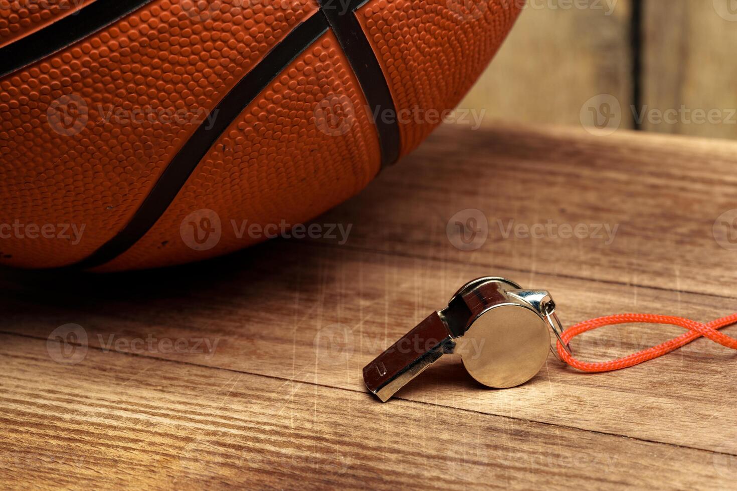 Basketball ball lying on a wooden floor photo