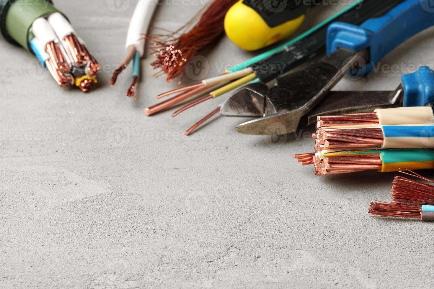 Electrical Tools and Wires on Gray Surface photo