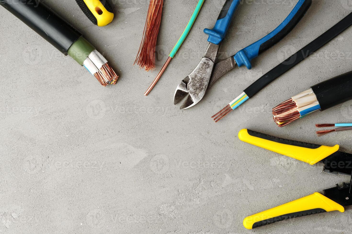 Electrical Tools and Wires on Gray Surface photo
