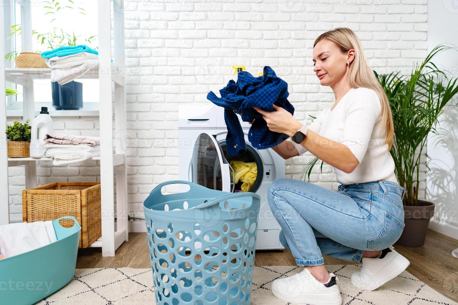 Woman Doing Laundry near a Washing Machine photo