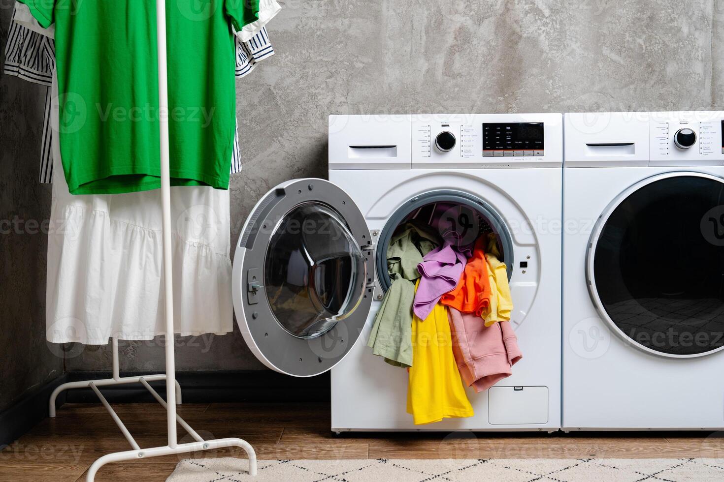 Open Front Loading Washing Machine With Colorful Clothes photo