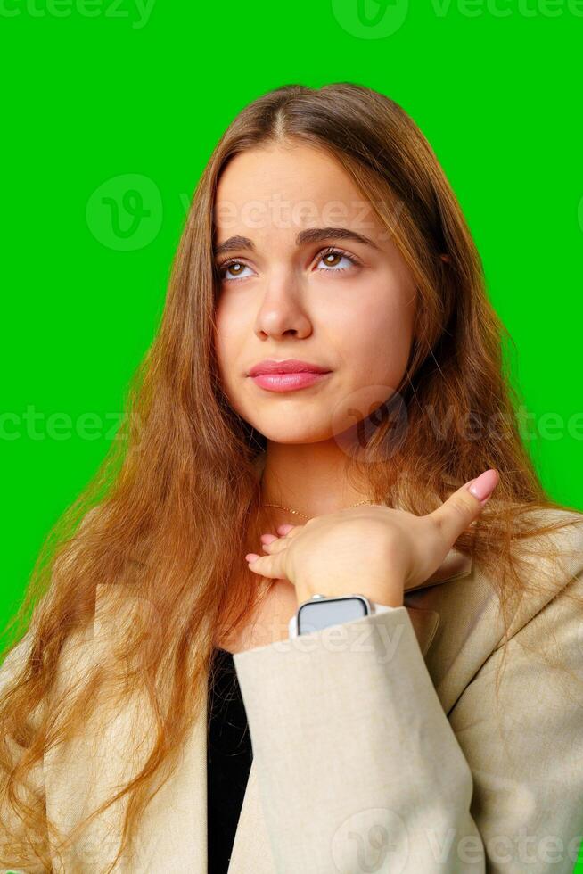 Young Woman Posing in beige Suit against green background photo