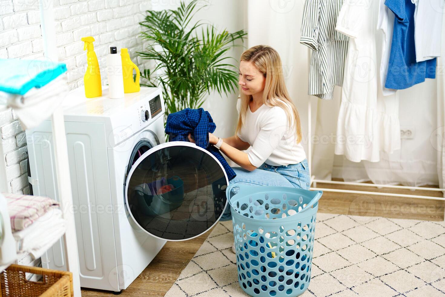 Woman Doing Laundry near a Washing Machine photo