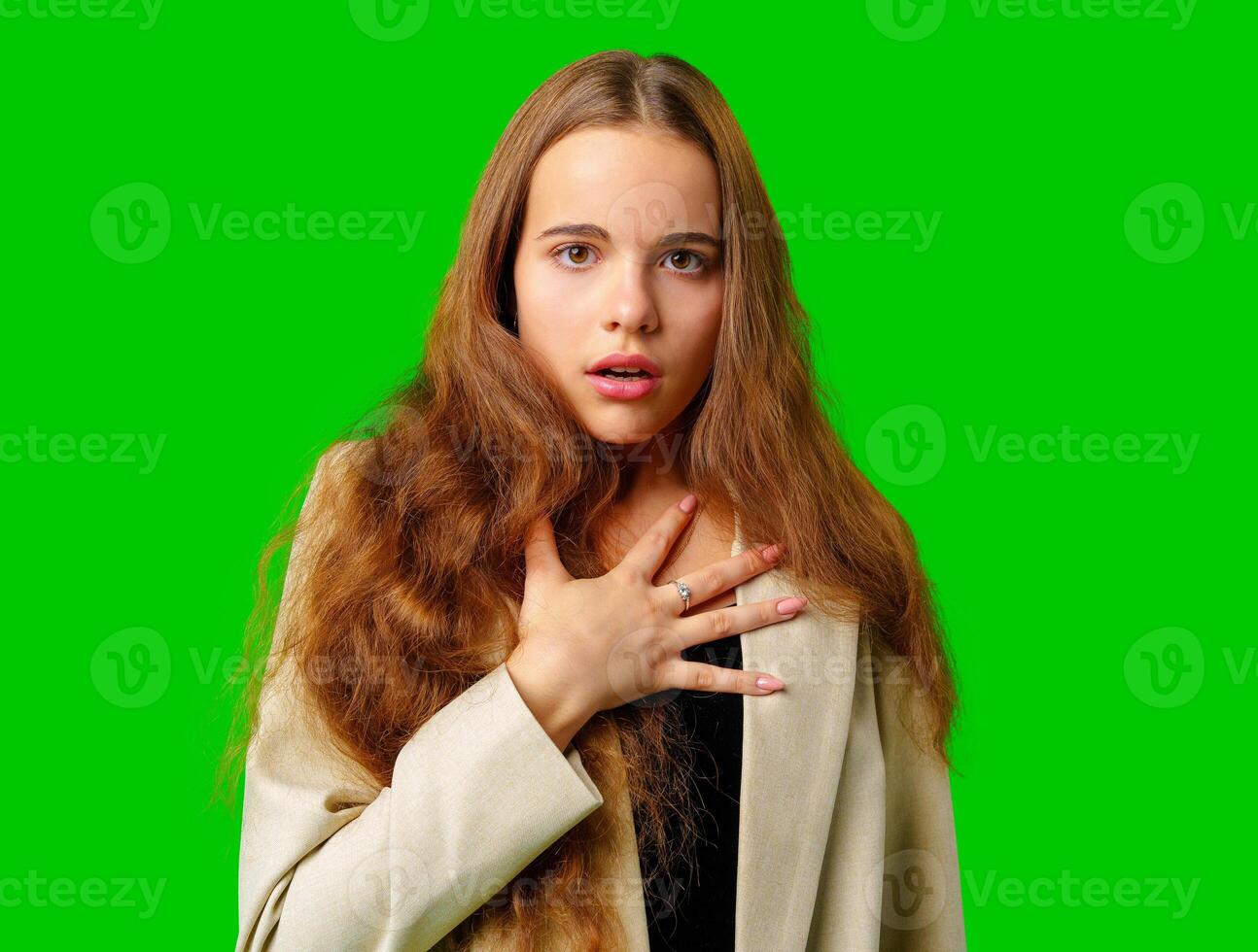 Young Woman Making a Surprised Face in Front of Green Screen photo