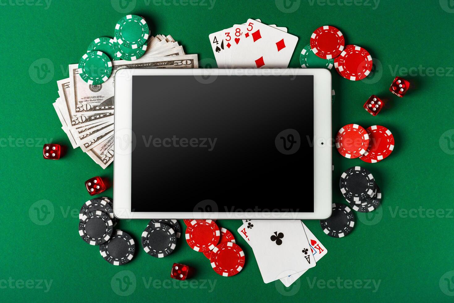 Online Casino Gambling With Tablet, Cards, Chips, and Dice On Green Felt photo