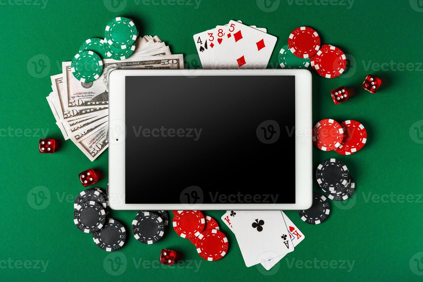 Online Casino Gambling With Tablet, Cards, Chips, and Dice On Green Felt photo