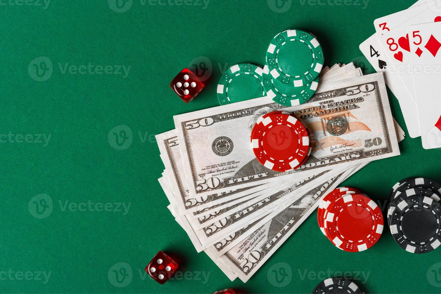 Red Dice, Playing Cards, and Chips on Green Felt Tabletop photo