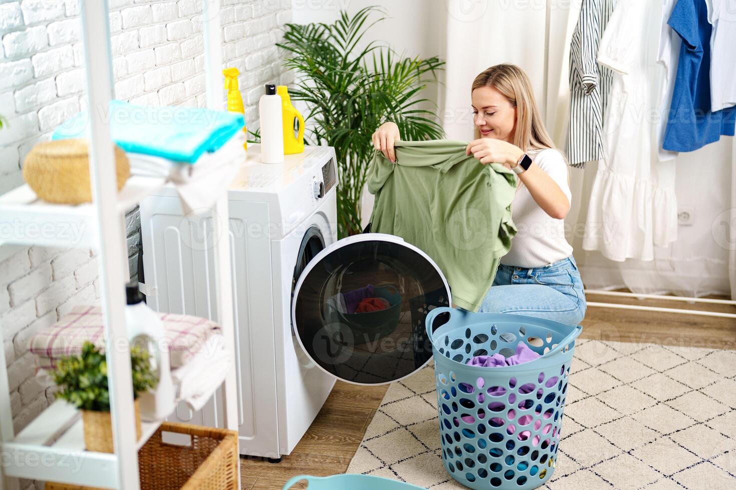 Woman Doing Laundry near a Washing Machine photo