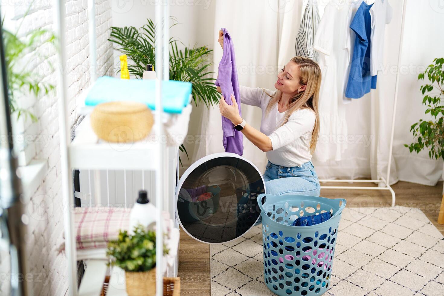 Woman Doing Laundry near a Washing Machine photo