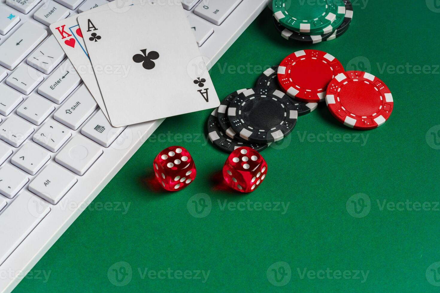 Playing Cards, Dice, and Chips on Green Felt Gaming Table With Keyboard photo