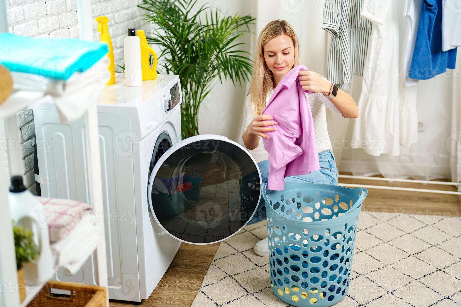 Woman Doing Laundry near a Washing Machine photo
