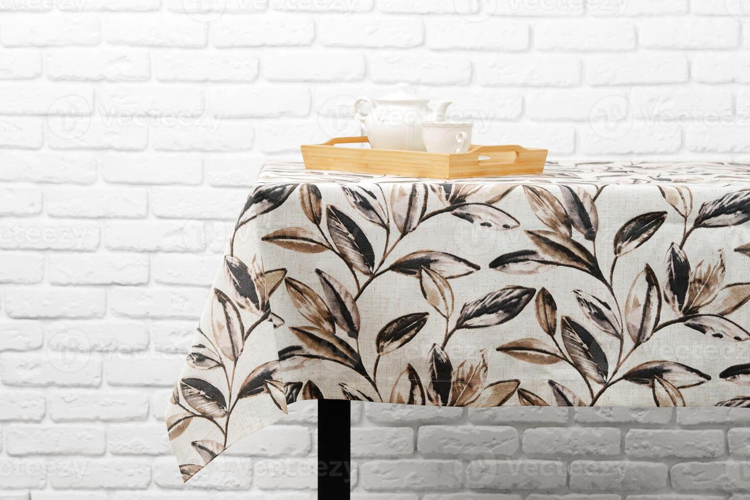 White Tablecloth With Brown Leaf Pattern Close Up photo