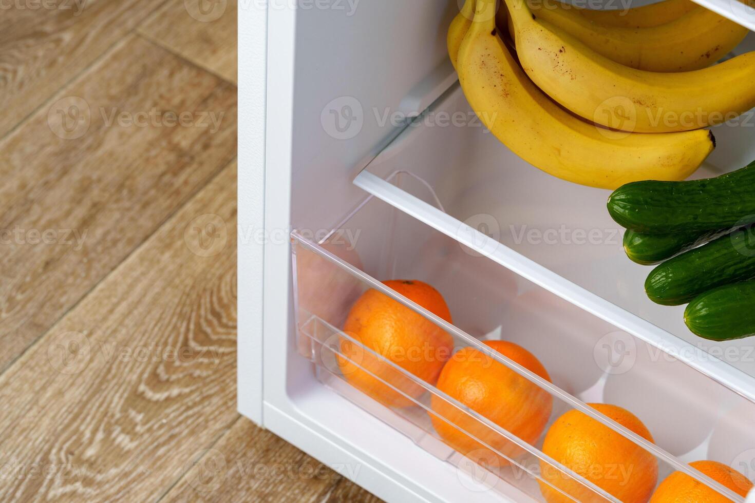 Open Refrigerator Door Showing Fresh Produce Inside photo
