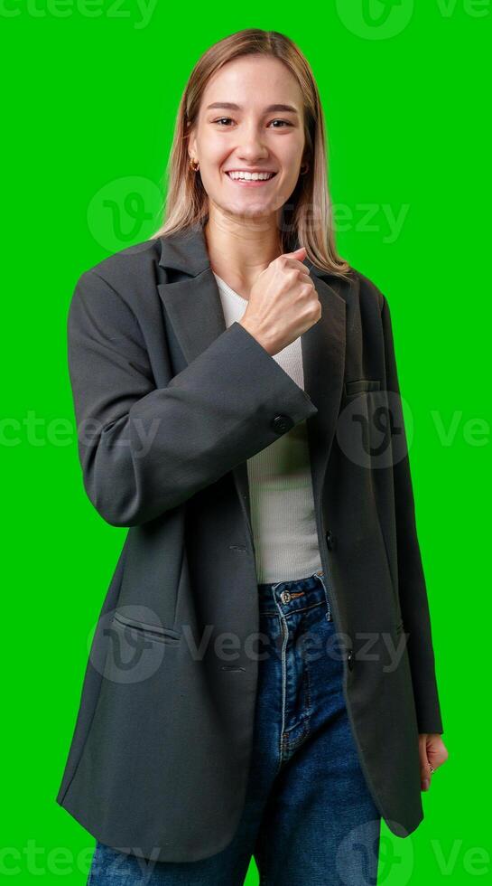 Smiling Woman Wearing Black Blazer and Jeans Against Green Screen photo