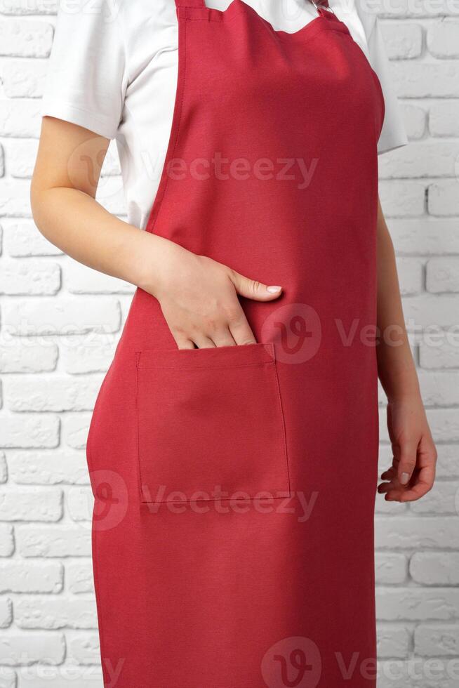 Close Up of a Woman Wearing a Red Apron With a Pocket photo