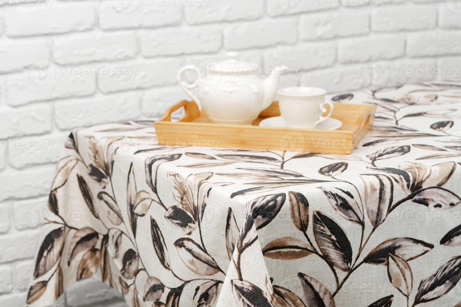 White Tablecloth With Brown Leaf Pattern Close Up photo