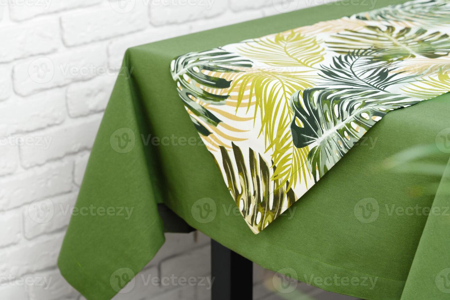 Green Tablecloth With Tropical Leaf Pattern Runner photo