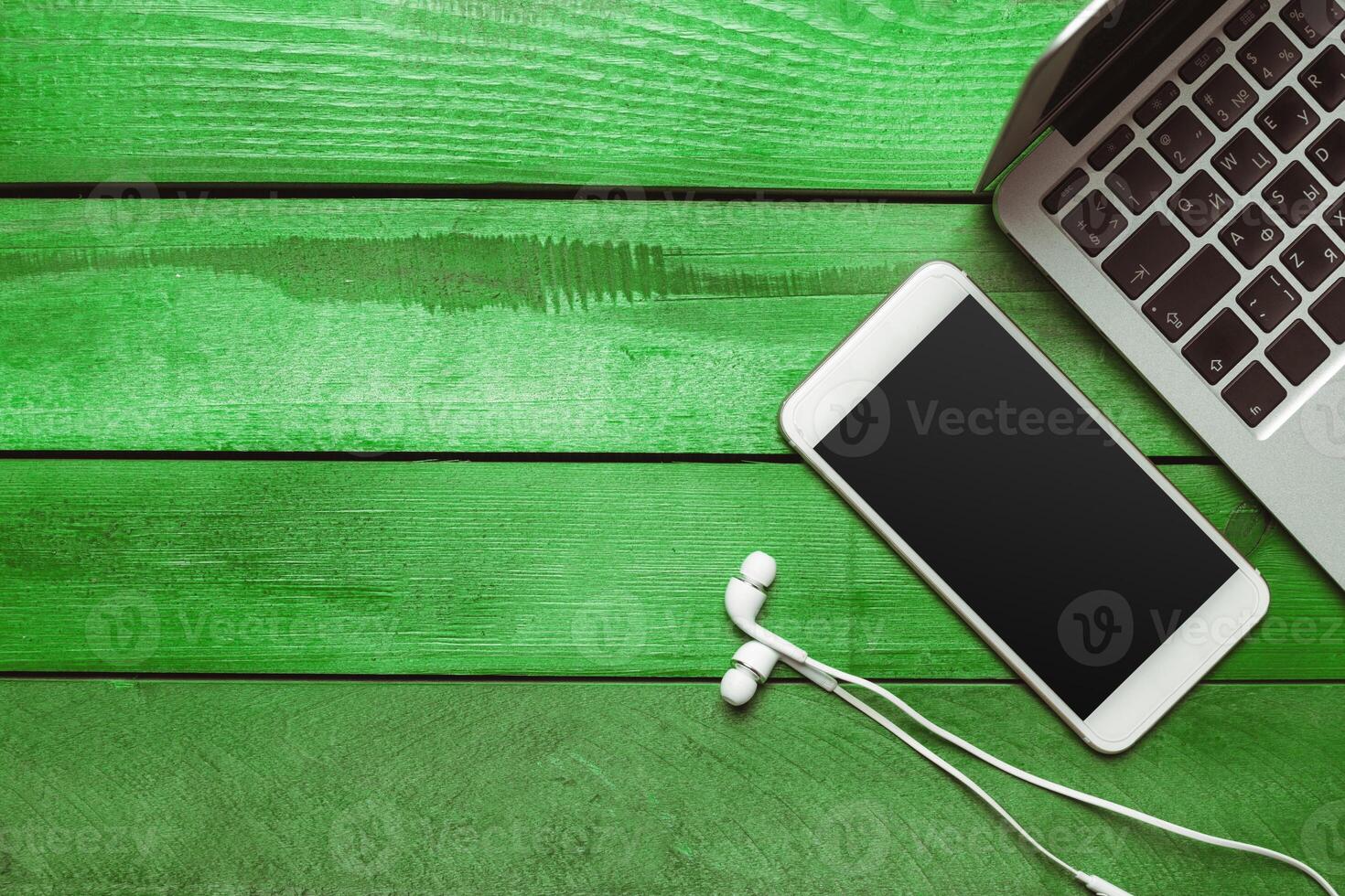 Office table with smartphone on it. View from above photo