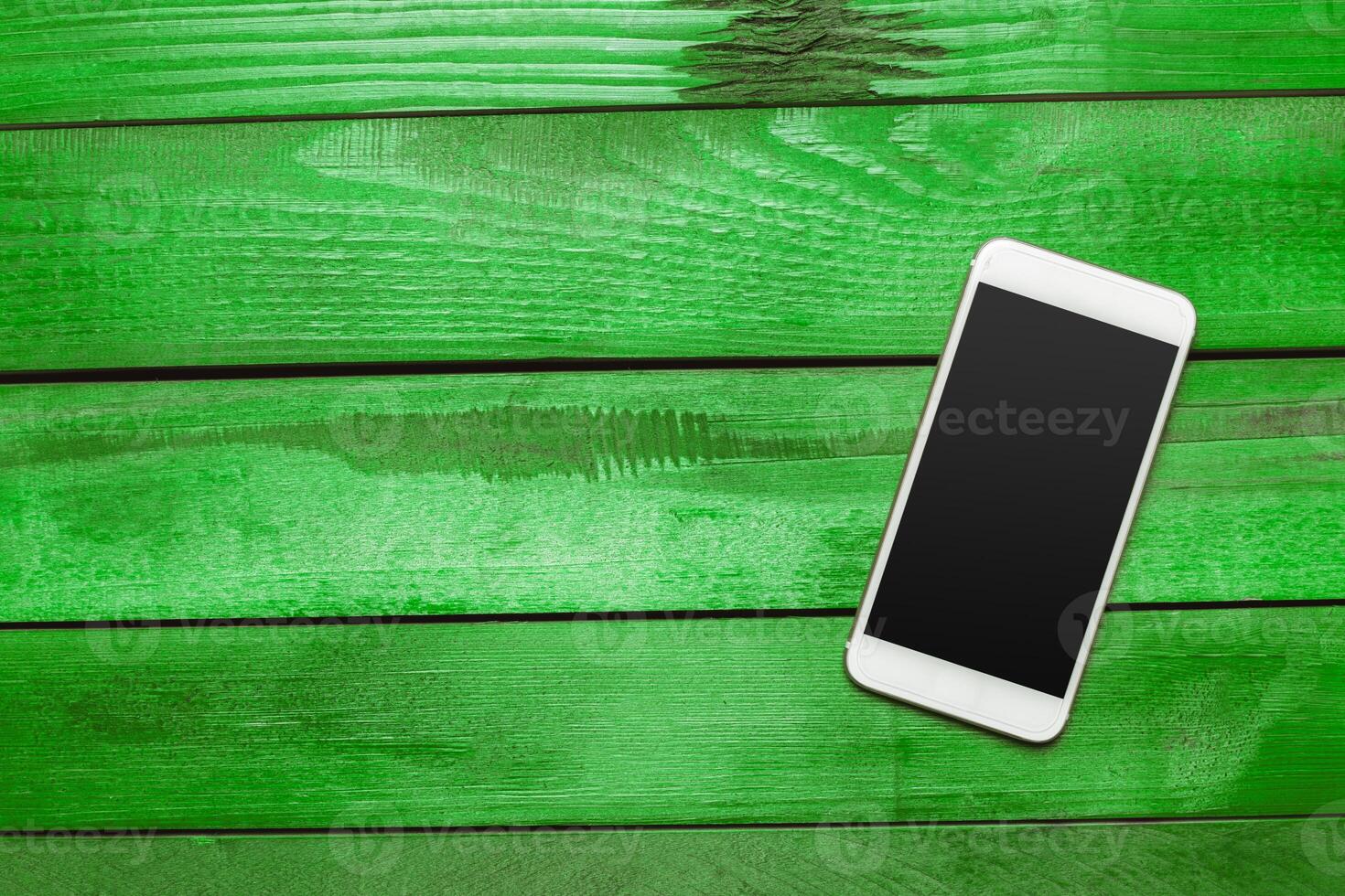 Office table with smartphone on it. View from above photo