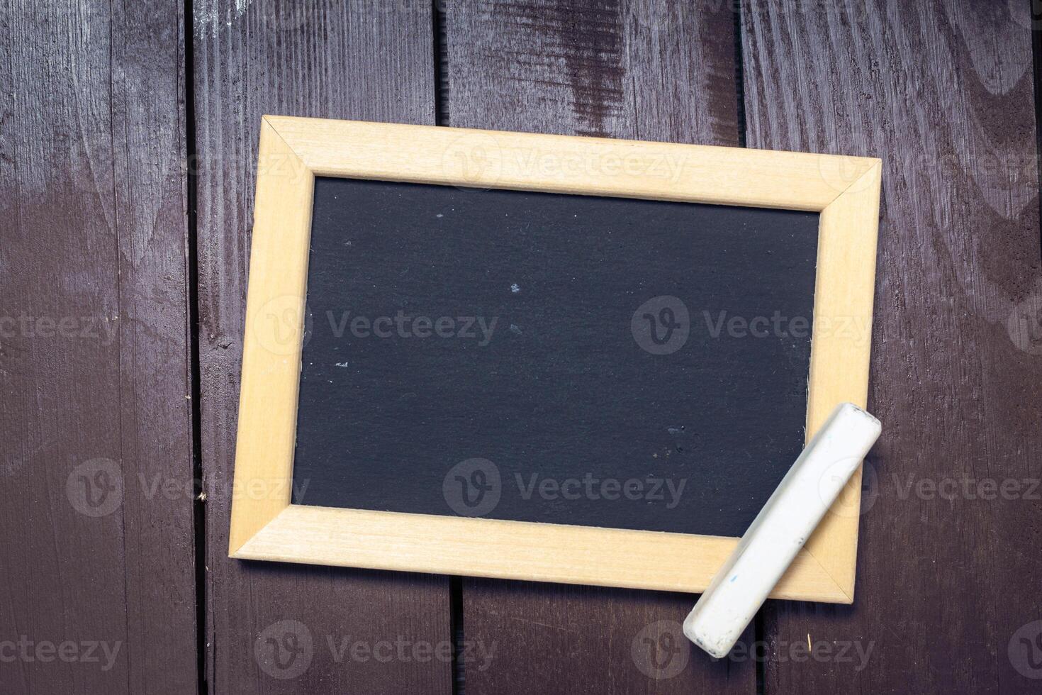 Small blackboard on old wood background photo