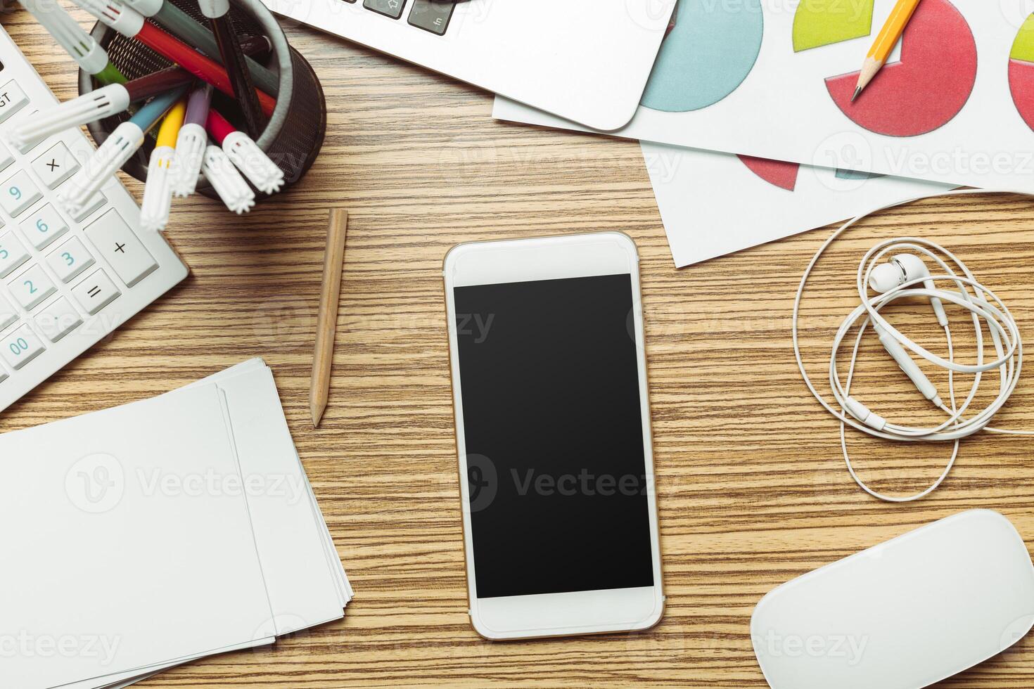 Office table with smartphone on it. View from above photo
