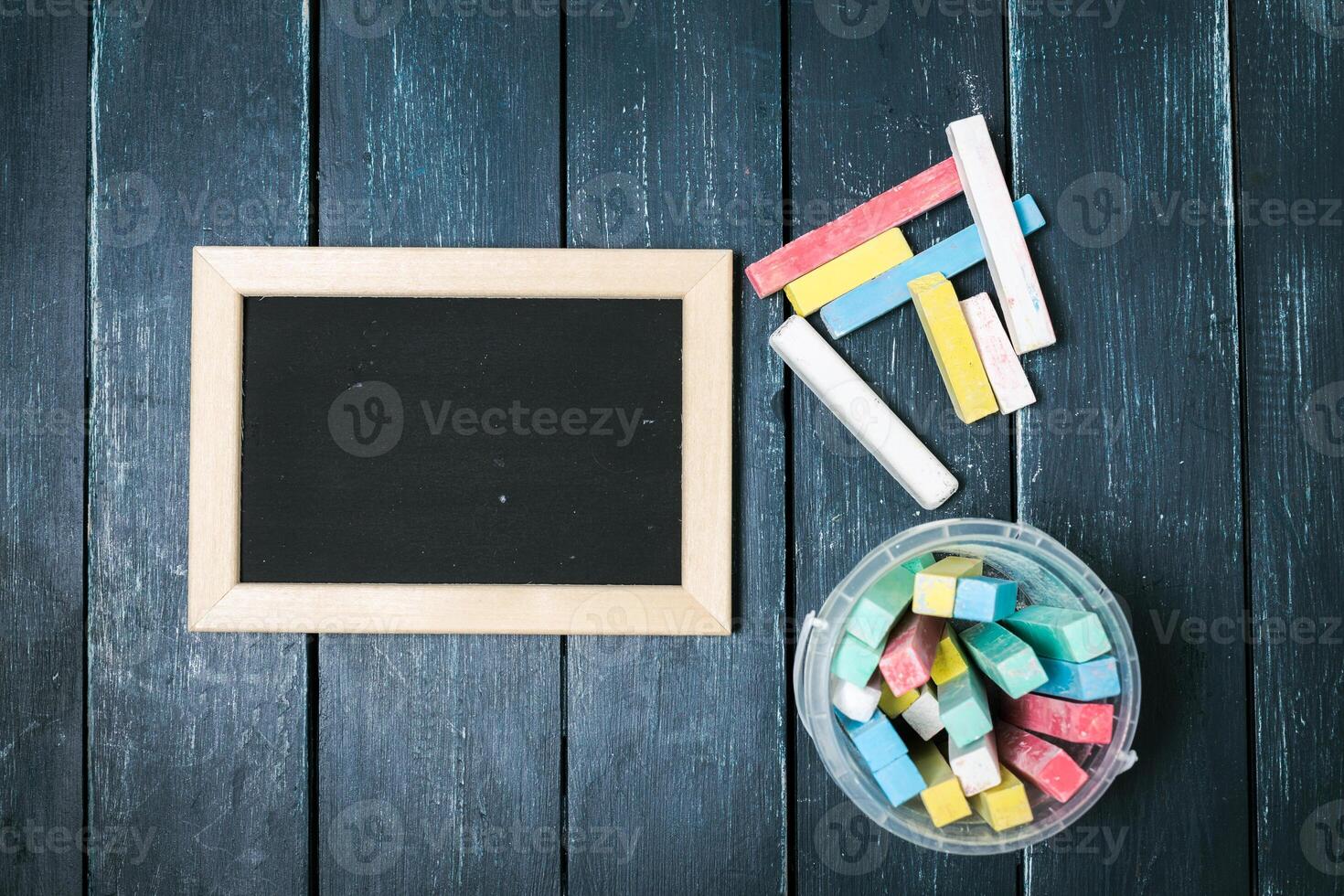 Small blackboard on old wood background photo