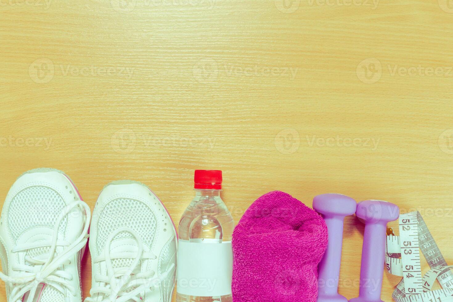 Shoes and sports equipment on wooden floor, top view photo