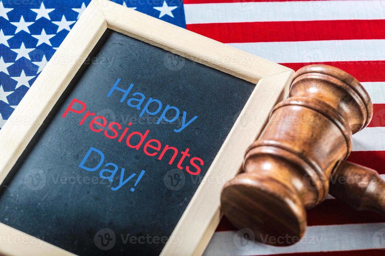 the text happy presidents day written in a chalkboard and a flag of the United States photo