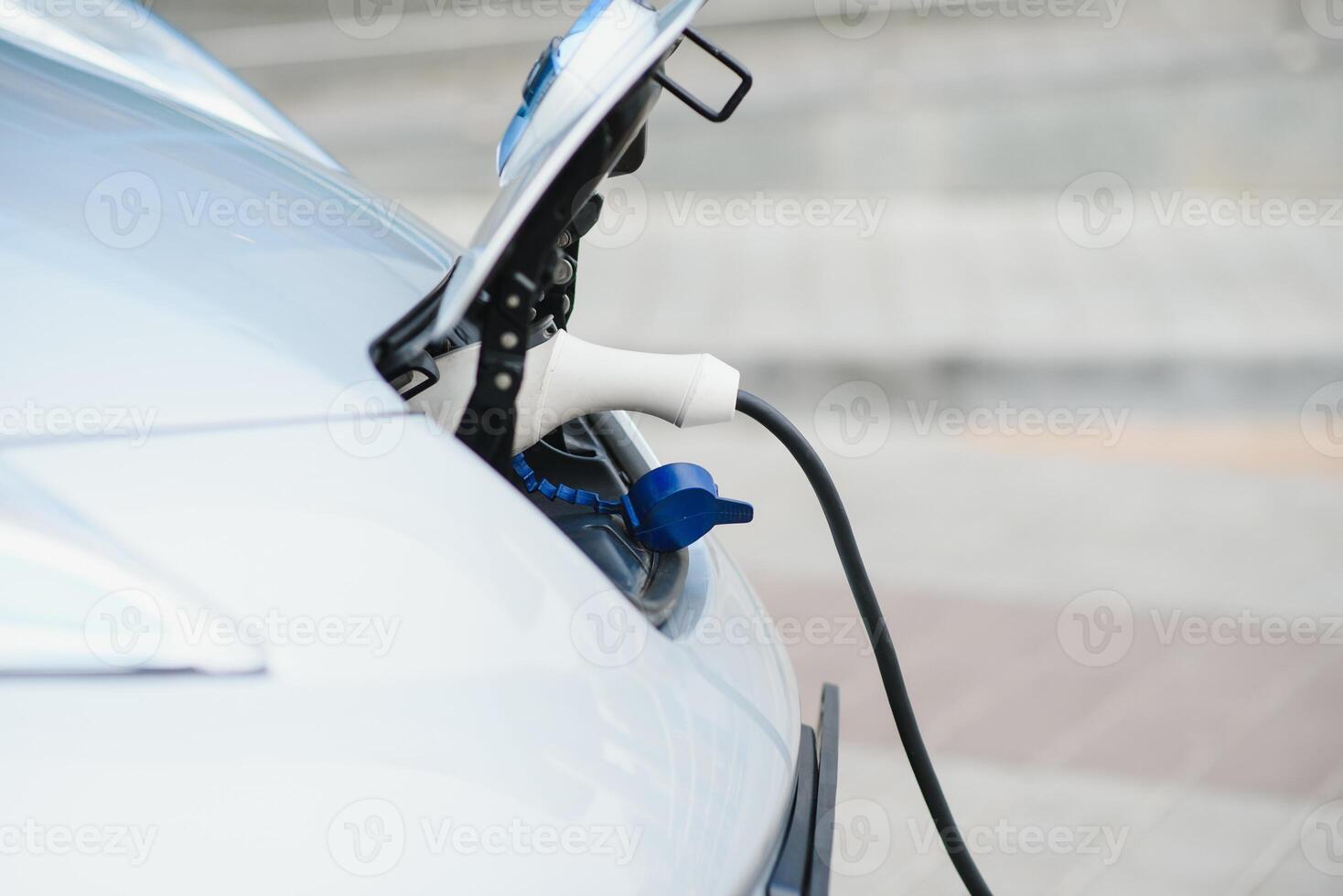 Charging an electric car with the power cable supply plugged in photo
