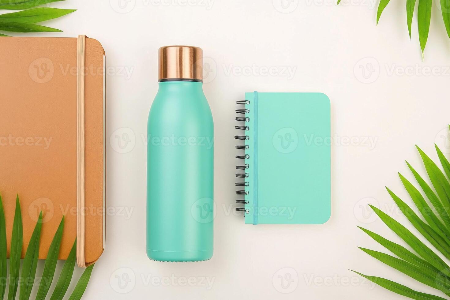 A flat lay of eco-friendly products showcasing a reusable water bottle and notebooks on a light background photo