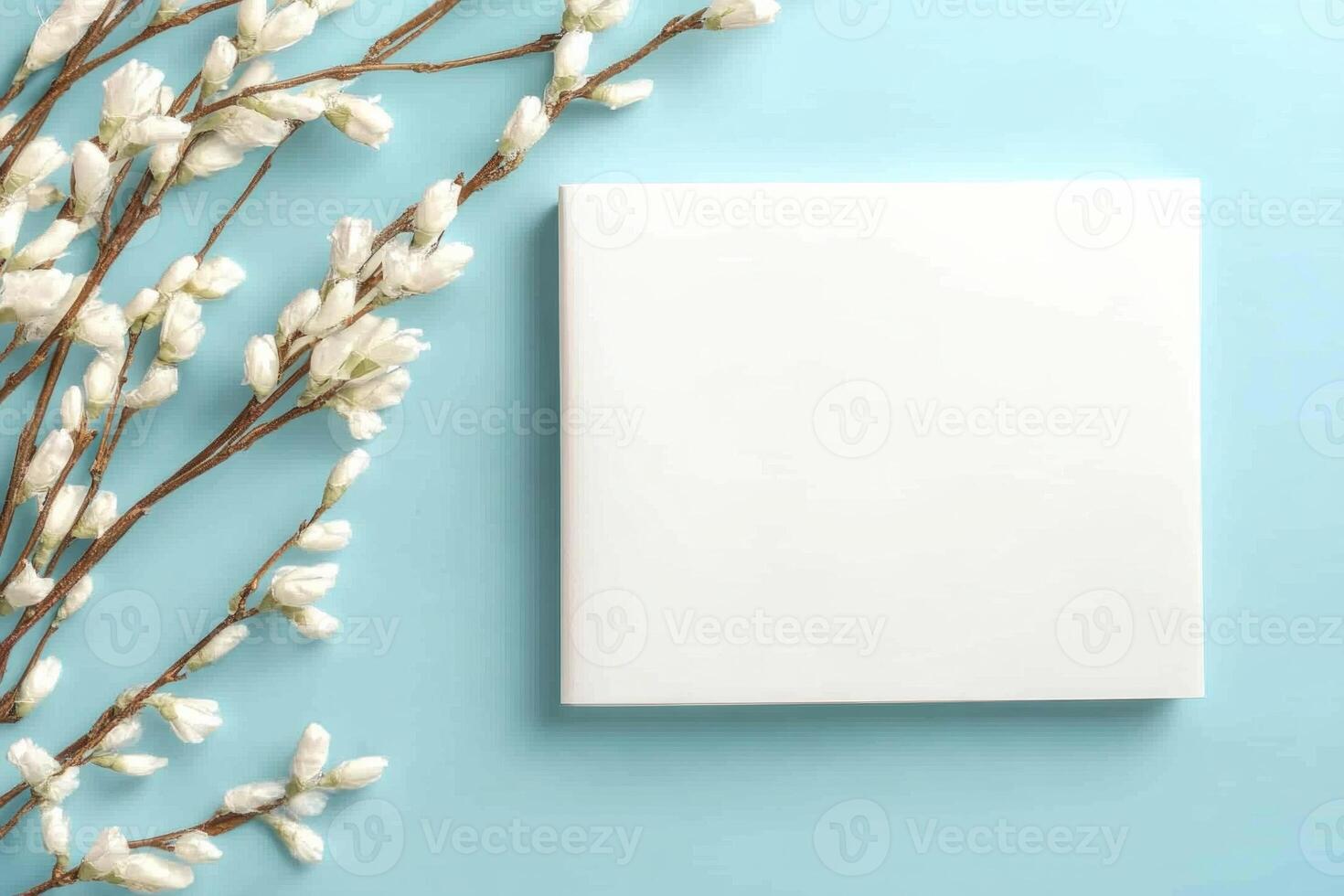 Elegant wedding invitation mockup with minimalist white card and willow branches on soft blue background photo