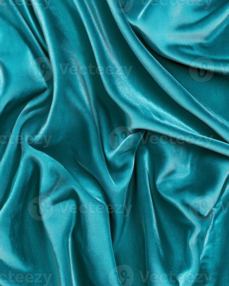 Dark teal velvet fabric texture showcasing softness and rich color in elegant folds with light reflections photo