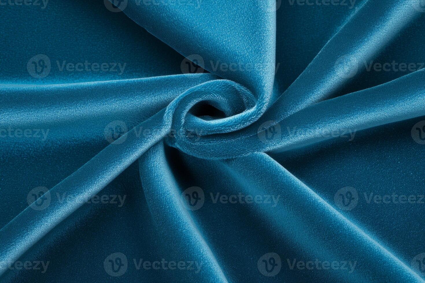 Close-up of rich dark teal velvet fabric showcasing luxurious texture and softness with light reflections photo