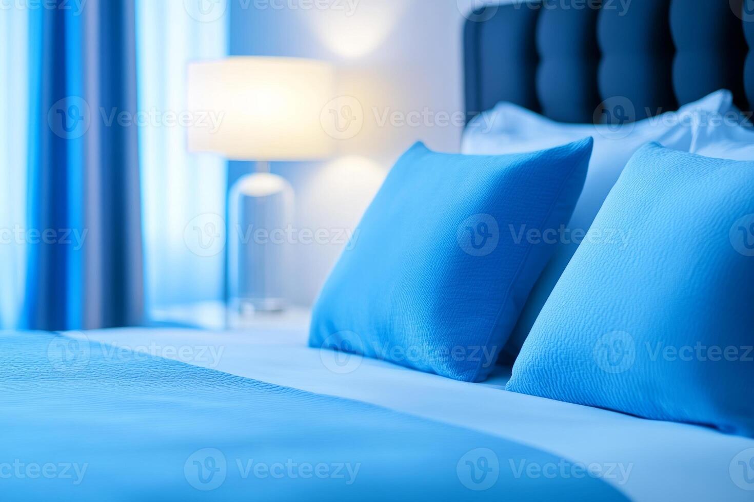 Luxurious silver bed adorned with deep blue bedding and elegant decor in a modern bedroom setting photo
