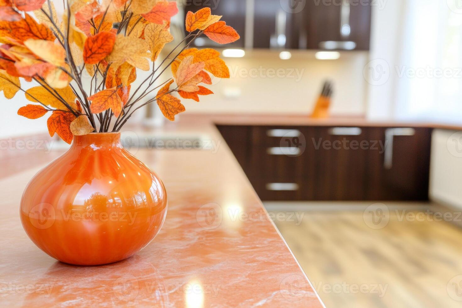 Modern kitchen featuring bold autumn accents with dark cabinets and pink marble countertops photo