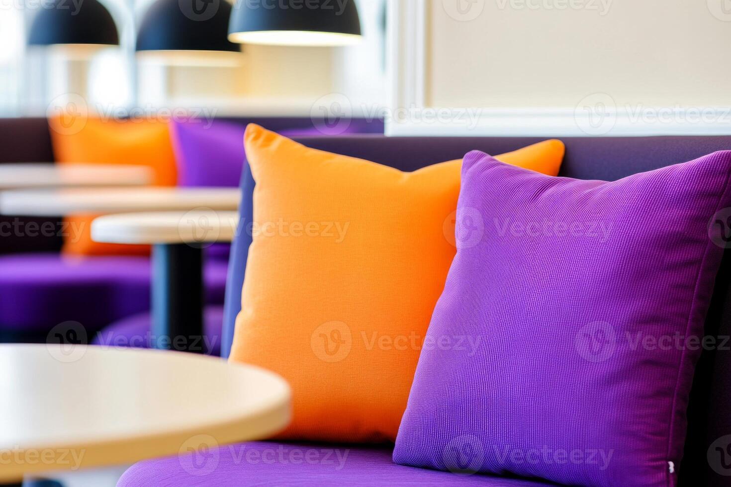 Cozy cafe interior with purple chairs and orange cushions in a warm setting perfect for relaxation photo