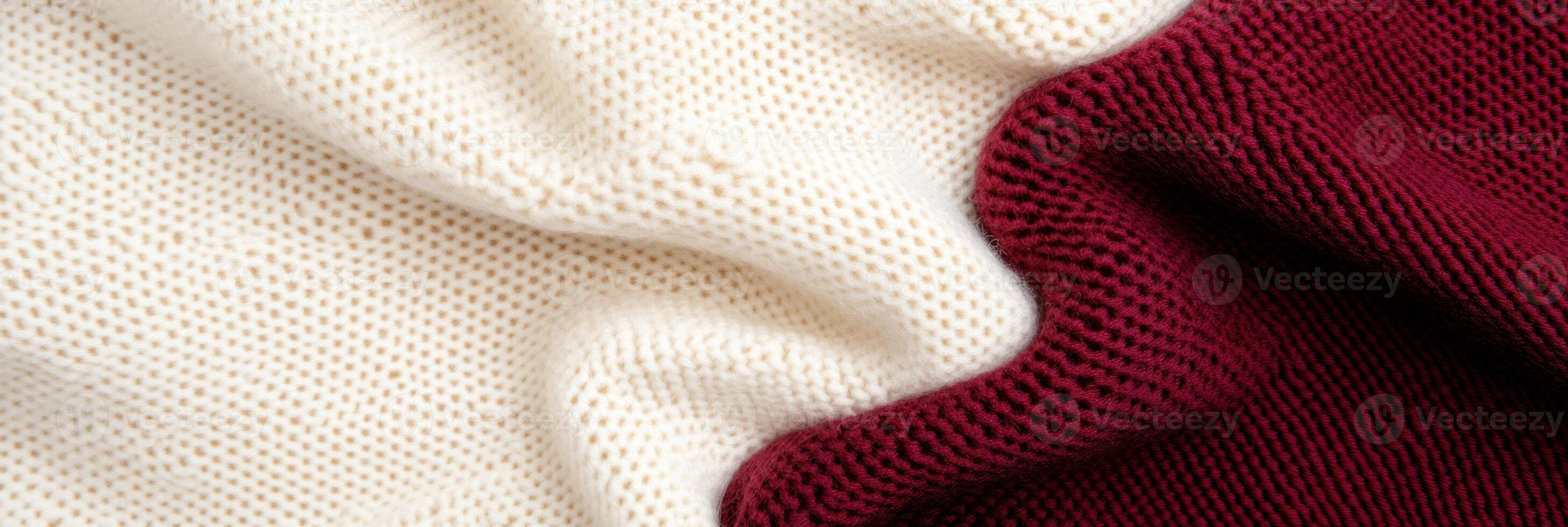 Close-up view of elegant fabric texture in rich burgundy and soft beige under warm lighting photo
