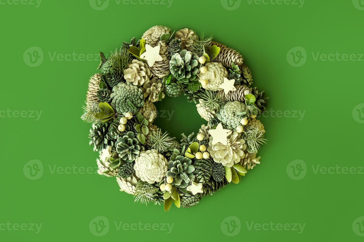 Christmas wreath in green and white tones on a monochromatic green background photo