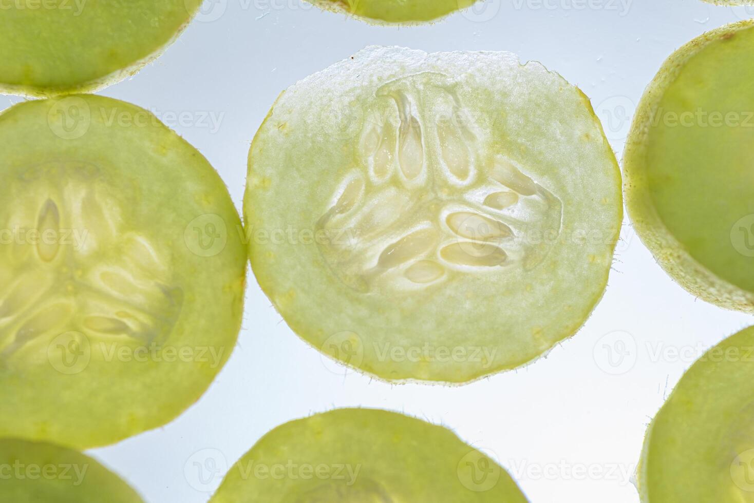 Armenian cucumber slices texture isolated on white background photo