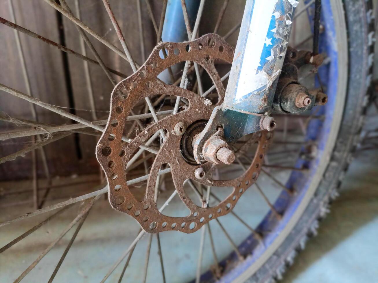 Close up of the old front part of the bicycle. Rusty gear. Vehicle, transportation concept. photo