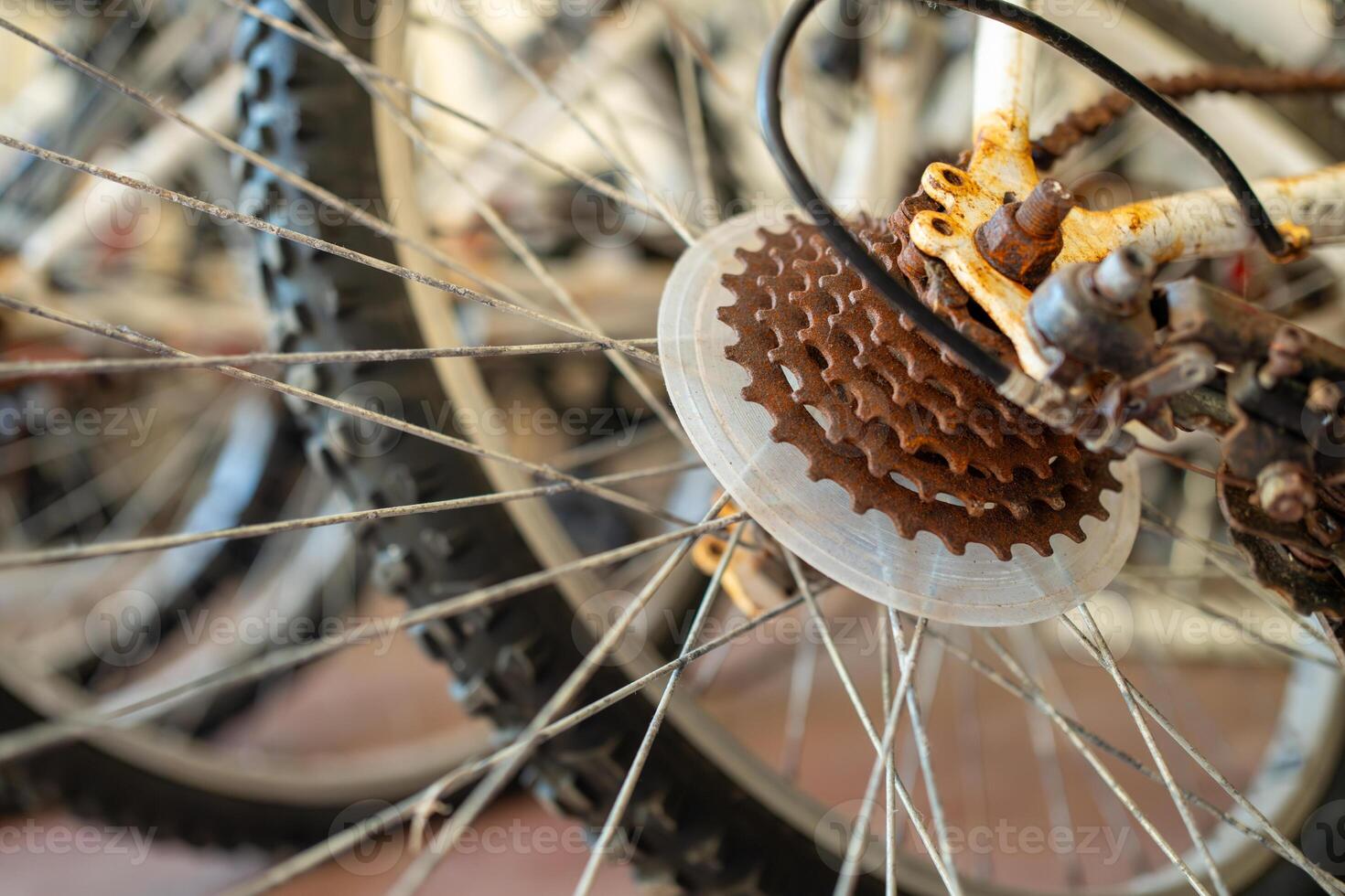 Detailed shot of rusty gears on bicycle tires during daytime photo