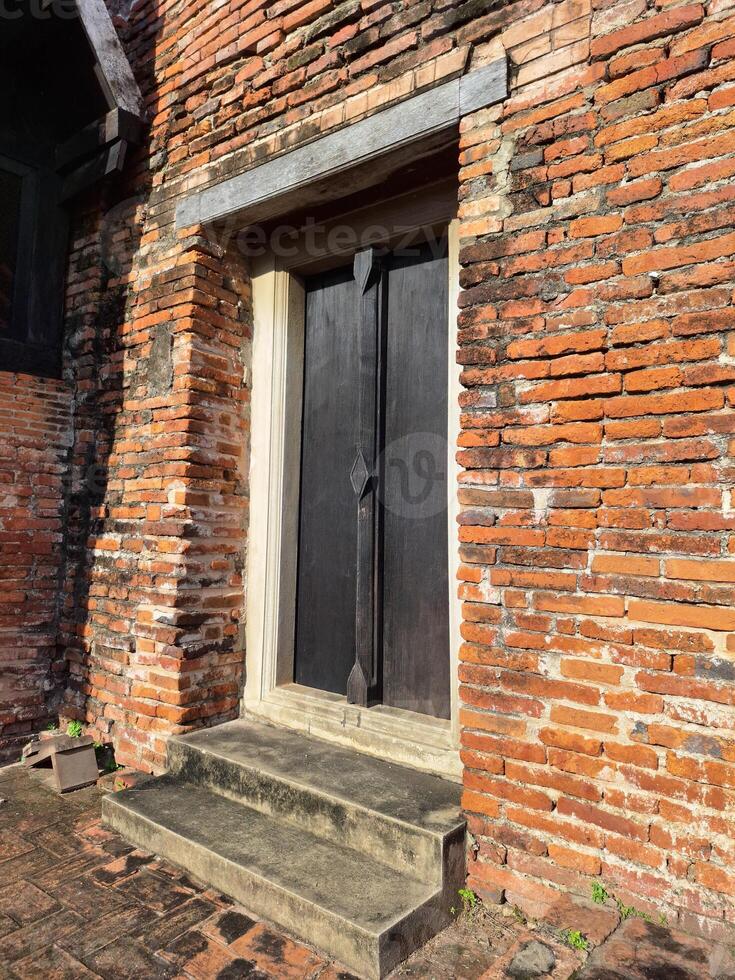 old wooden door in brick wall photo