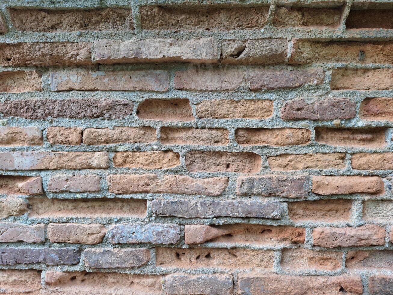 The old brick walls of the ancient site are damaged and broken. photo
